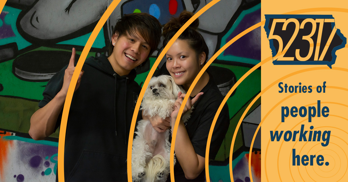 Joel and Liz against the painted mural background of the studio.