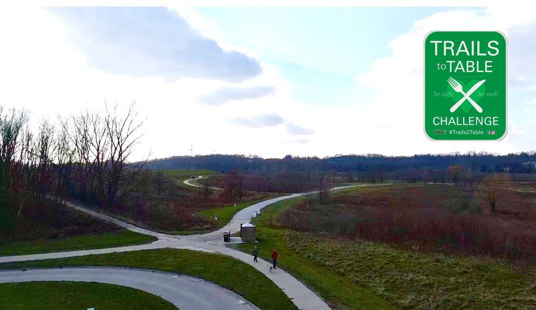 An areal view of trails in the metro area with the Trails to Table logo.