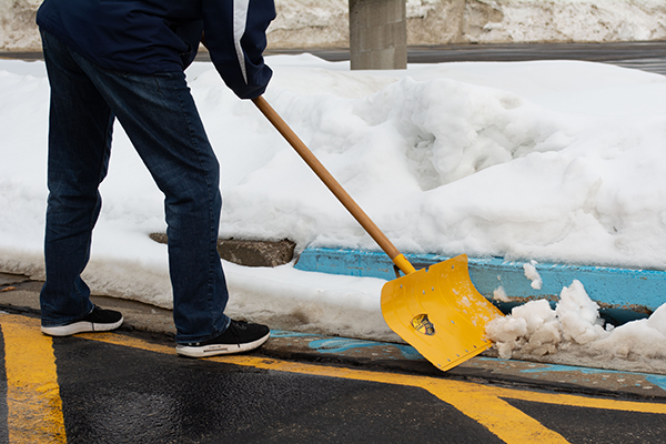 City staff clearing a storm drain intake.