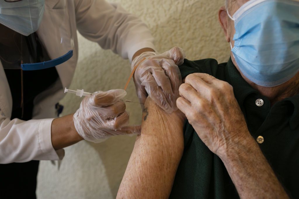 Senior receiving vaccine
