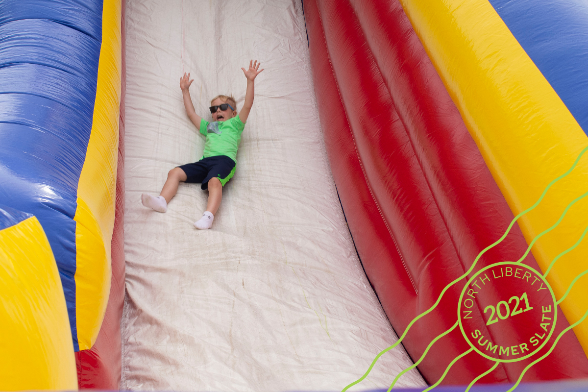 a kid going down an inflatable slide