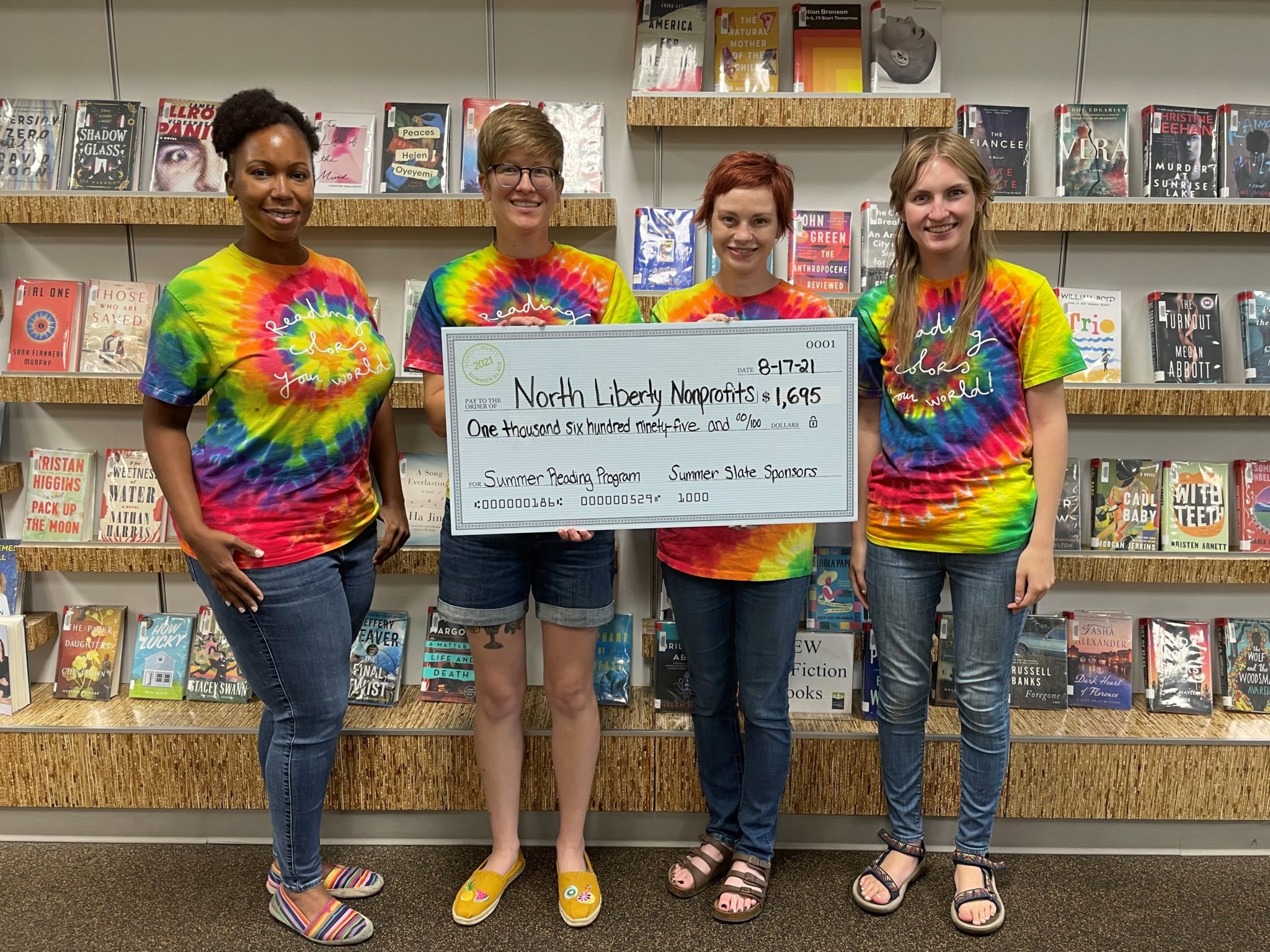 Librarians holding donation check