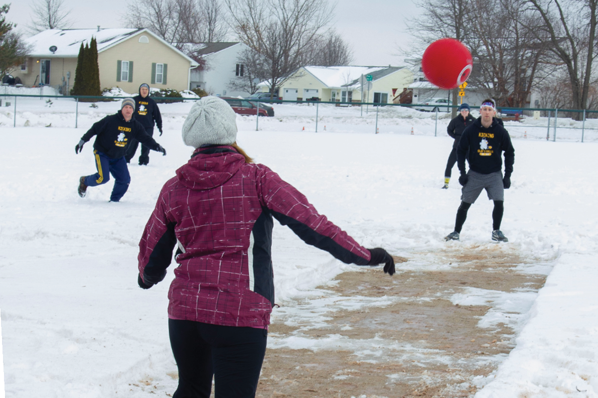 people throwing a ball in the snow