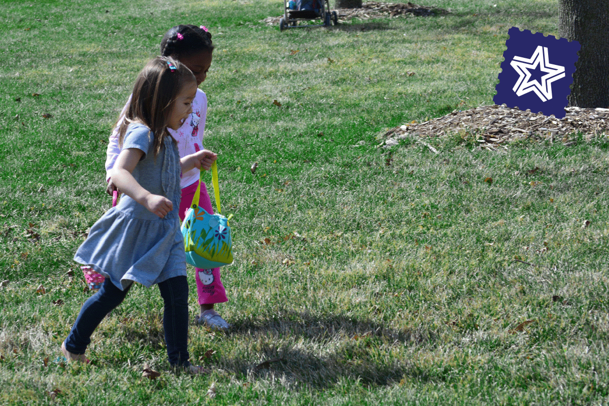 Two children walk through the grass in spring, searching for answers to solve the puzzle.