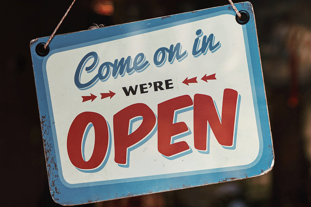 A sign in a window that reads "Come on in we're open".