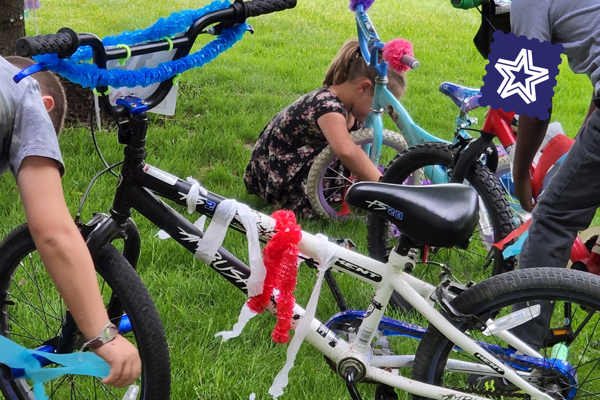 Children decorating bikes with streamers