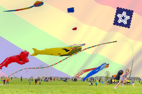 Child running among large kites
