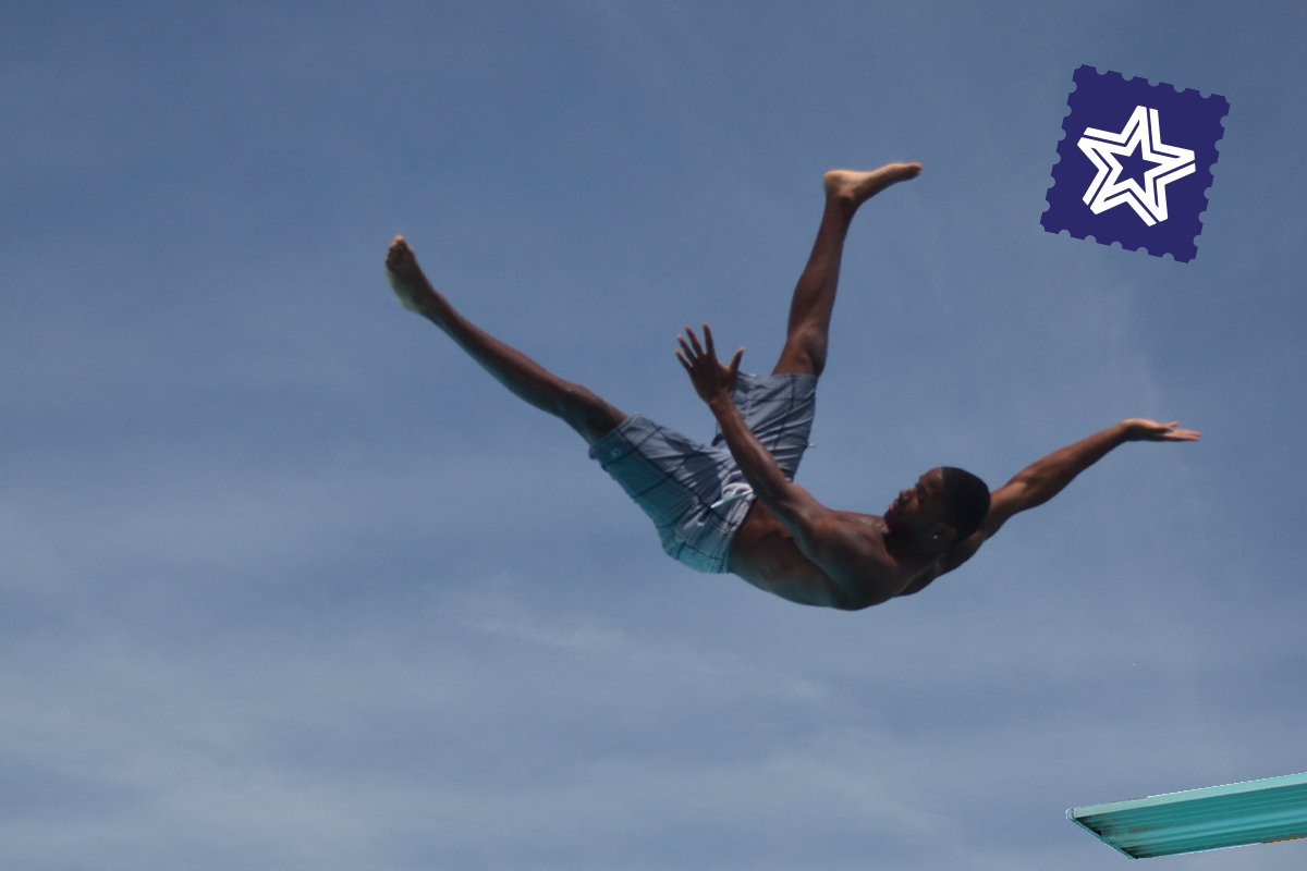 Teen jumping off diving board