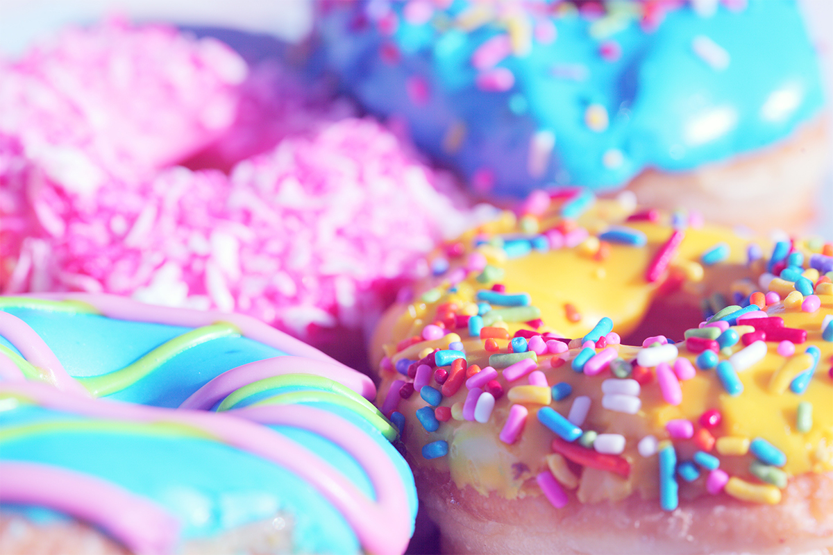 Doughnuts, with a variety of colorful toppings, with a shallow focus
