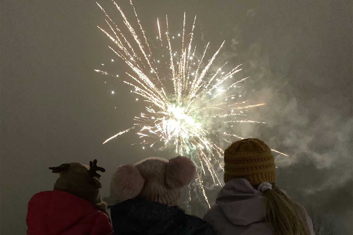 Premium Photo | People watch fireworks from a balcony