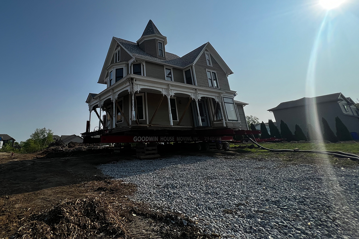 The George House, a Victorian home built in the early 1900s, is on a truck to be moved.