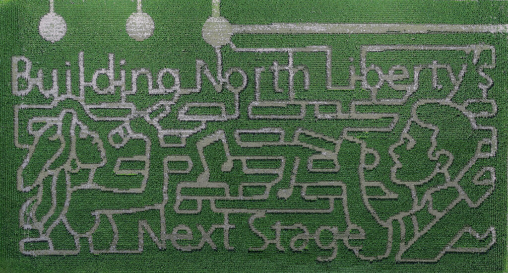 Building North Liberty's Next Stage written in corn maze