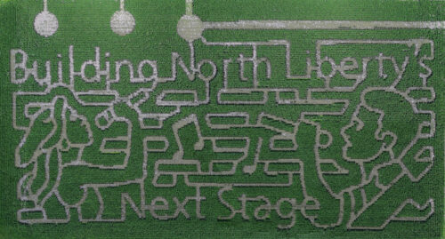 Building North Liberty's Next Stage written in corn maze