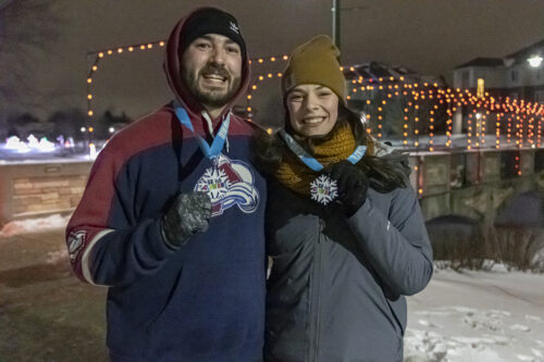 A couple standing with finisher medals