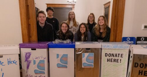 youth council members with donation boxes for hygiene products drive