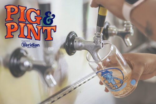 photo of someone holding a glass to a beer draft