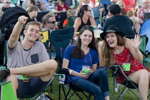 friends sitting on lawn chairs at an outdoor event