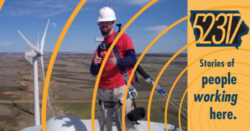 jesse bermel, a local hero standing atop a giant wind turbine, dangerously high up, but safely tethered so as not to be in any real danger - which is probably for the best.